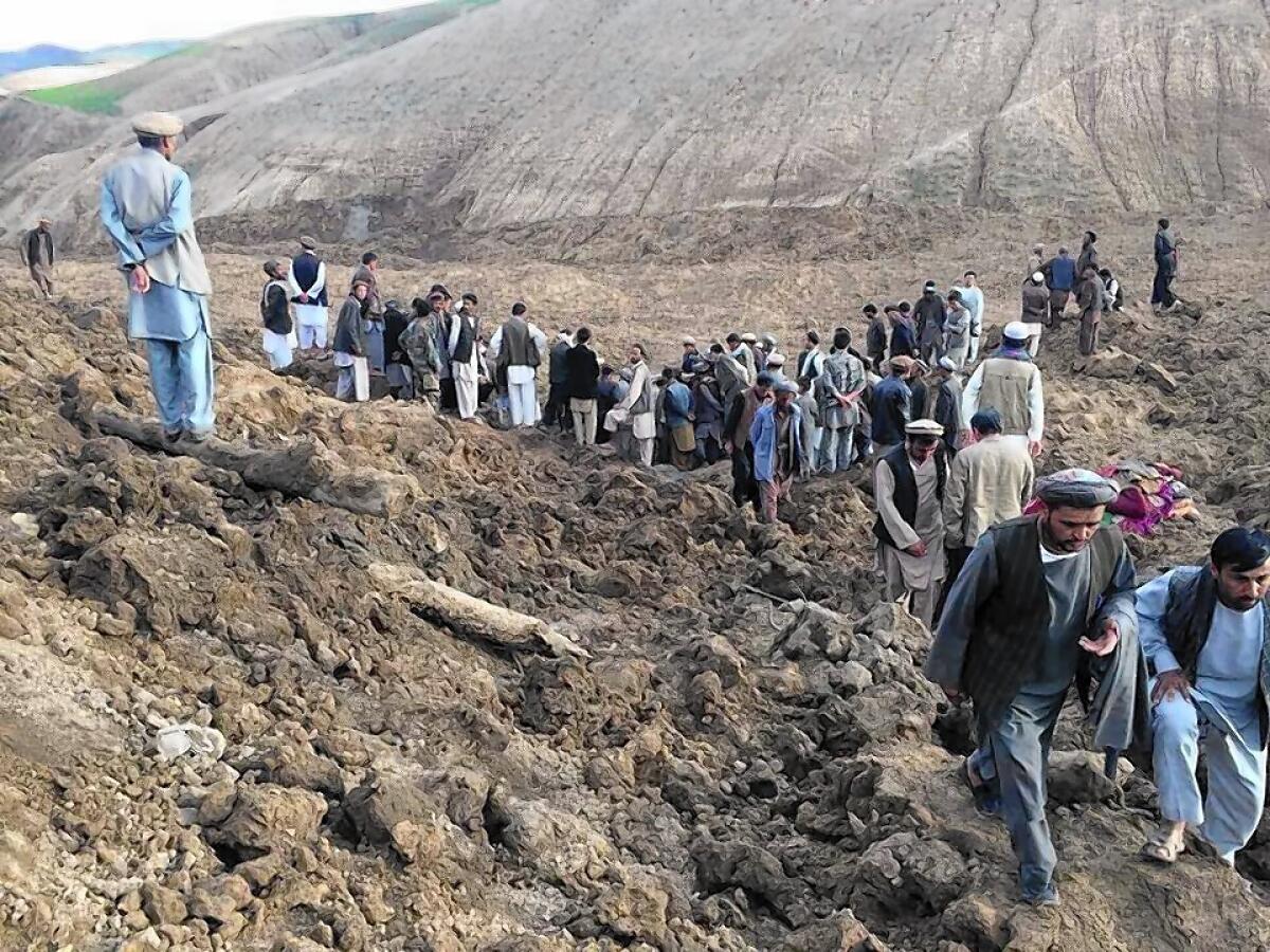 Afghans search for survivors after massive landslides buried a village in Badakhshan province, in the remote northeast.