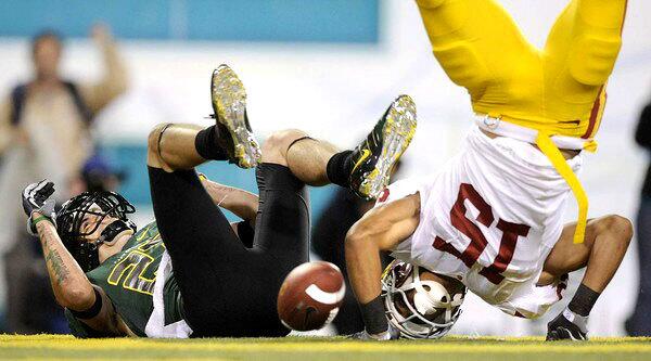 USC cornerback Kevin Thomas lands awkwardly after breaking up a pass intended for Ducks receiver Jeff Maehl in the end zone on Saturday.