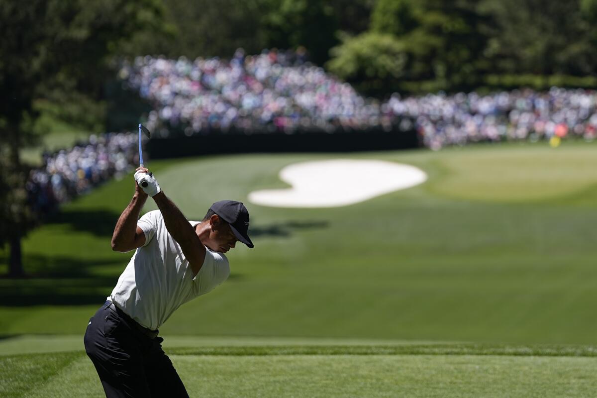 Tiger Woods hits off the fourth tee during the third round of the Masters on Saturday.