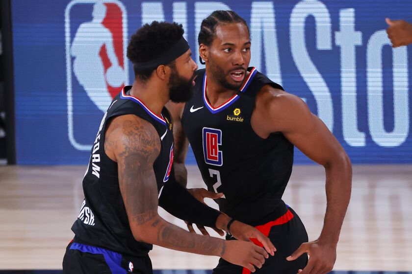 Los Angeles Clippers' Kawhi Leonard (2) reacts with teammate Marcus Morris Sr., left, after hitting a jump shot.