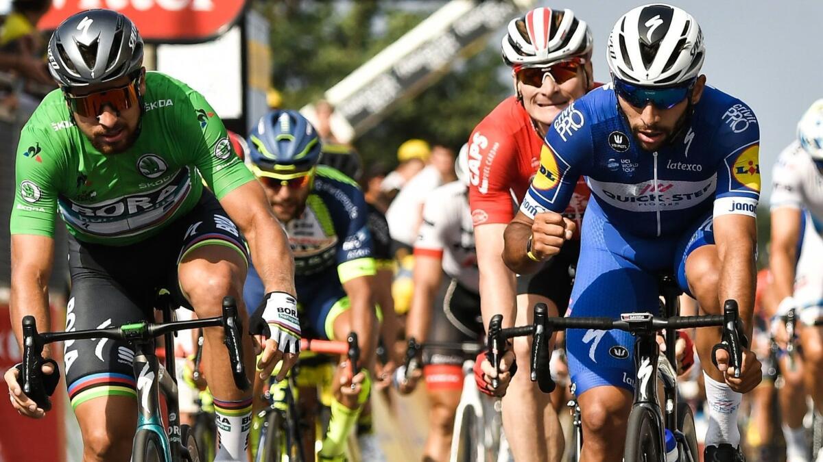 Fernando Gaviria, right, reacts after crossing the finish line ahead of Peter Sagan, left, and Andre Greipel, second from right.