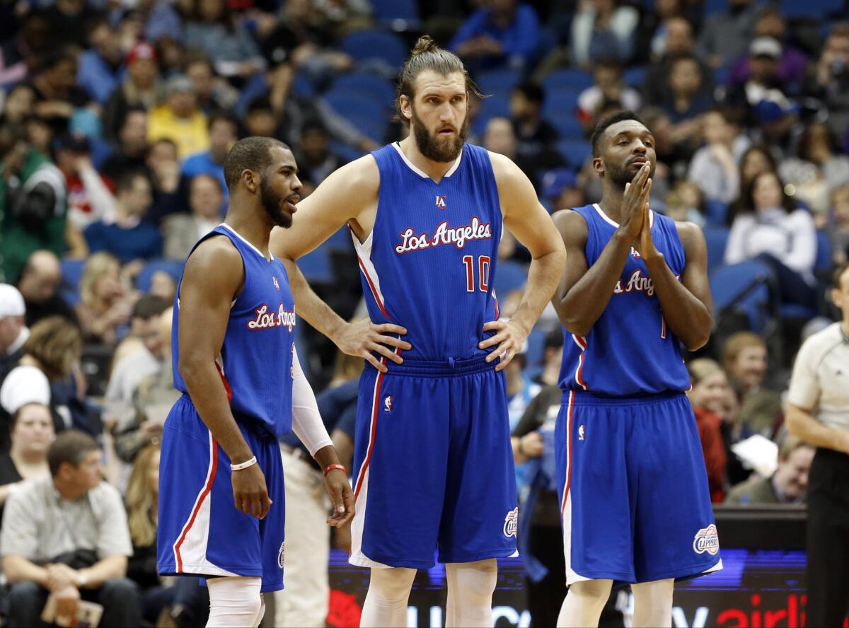 Chris Paul, Spencer Hawes and Jordan Hamilton talk during a break in the second half of a game March 2 against the Minnesota Timberwolves.
