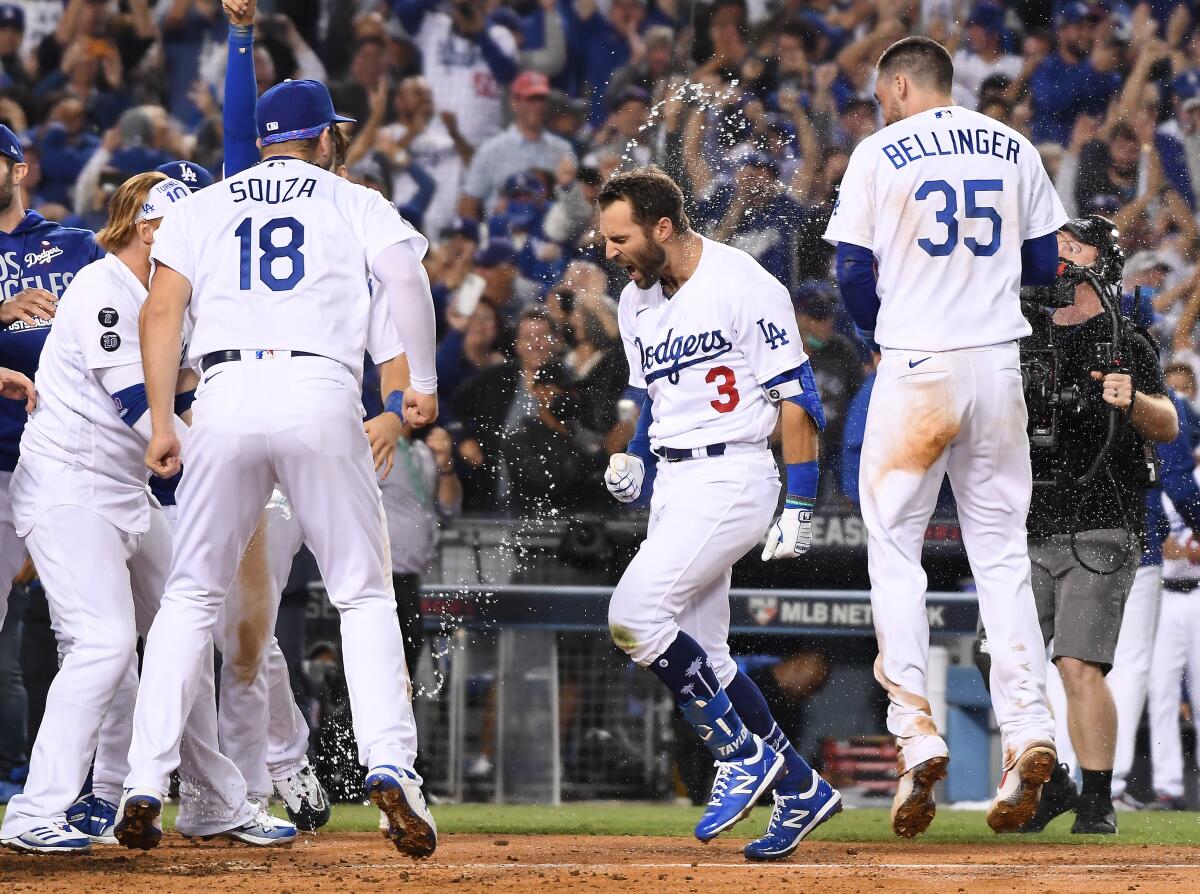 Dodgers left fielder Chris Taylor celebrates while crossing home after hitting the game-winning two-run home run.