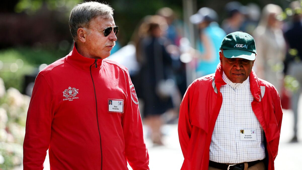 Rams owner Stan Kroenke, left, chatting with Ananda Krishnan, a Malaysian businessman and philanthropist, during a business conference, is at the forefront of NFL owners' meetings this week.