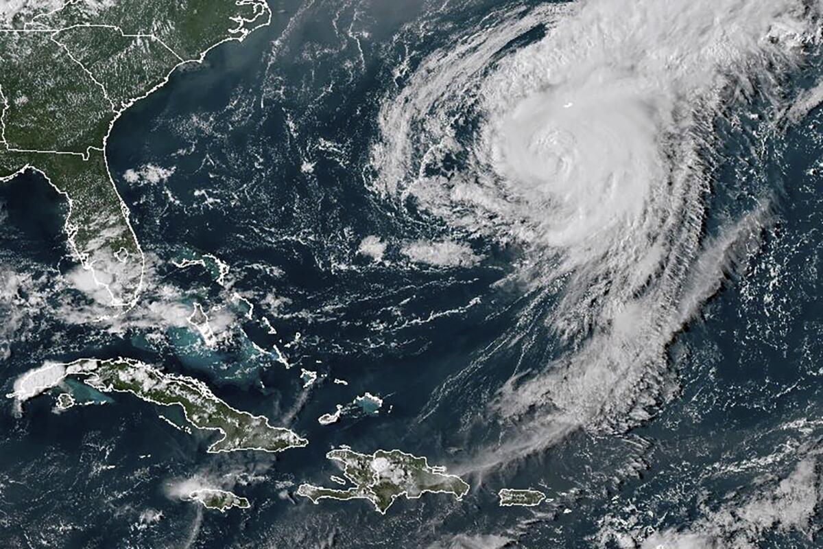 A satellite image showing a swirling white mass in the Atlantic Ocean off the U.S. East Coast and the Caribbean islands