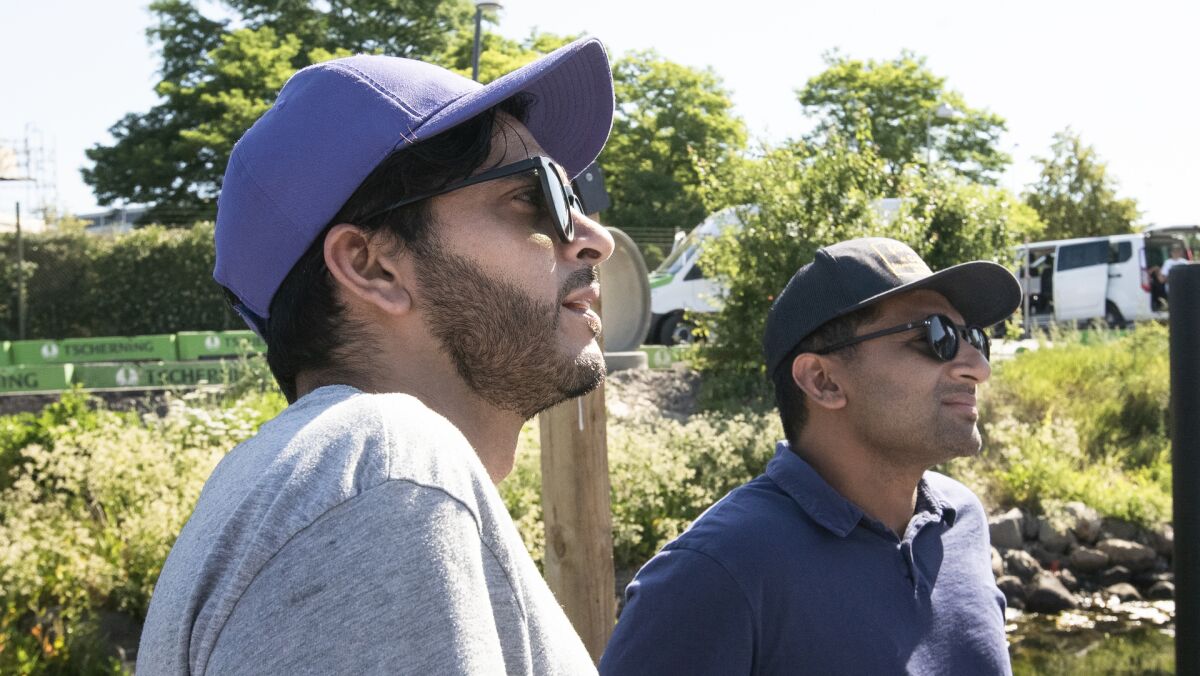Abdullah Saeed, left, and Ravi Patel sit and listen in the "Immigrants & the Border in Denmark" episode.