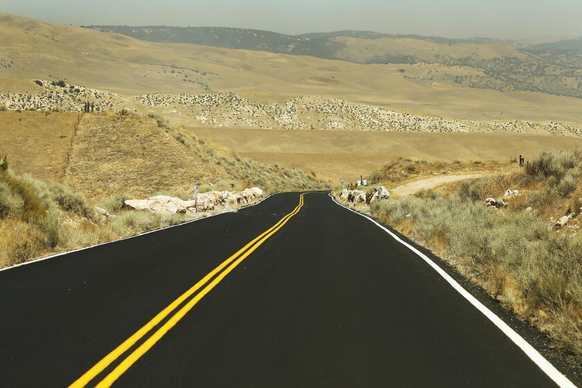 TEJON RANCH, CA â€“ AUGUST 06, 2018: A newly paved road in the Oso Drainage Open Space in the flat, windy sprawling grasslands of native and non-native scrub on Tejon Ranch where Centennial, the 12,000 acre proposed master planned community of the ranch off Highway 138, if approved, would bring in up to 19,333 residences, a mix of single-family, multi-family and apartment units, with a business park and open space around their periphery. (Al Seib / Los Angeles Times)