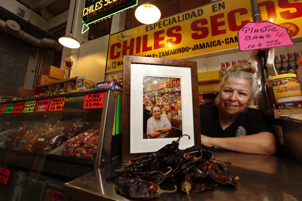 Second-generation Chiles Secos owner Rocio Lopez with a photo of her father, founder Celestino Lopez.