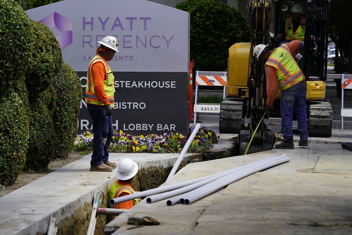 Workers install piping for underground electrical lines in Sacramento.