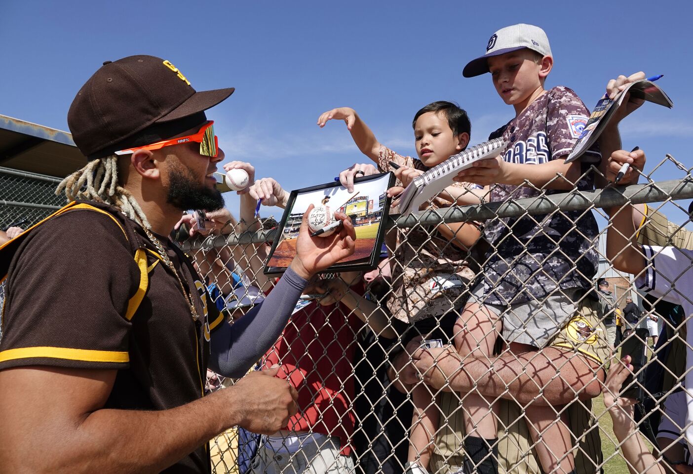San Diego Padres Fernando Tatis. Jr. signs autographs for Brandon Llantada, 6, and Cleighton Baccarelli, 7, from Rancho Peñasquitos after a spring training practice on Feb. 18, 2020.