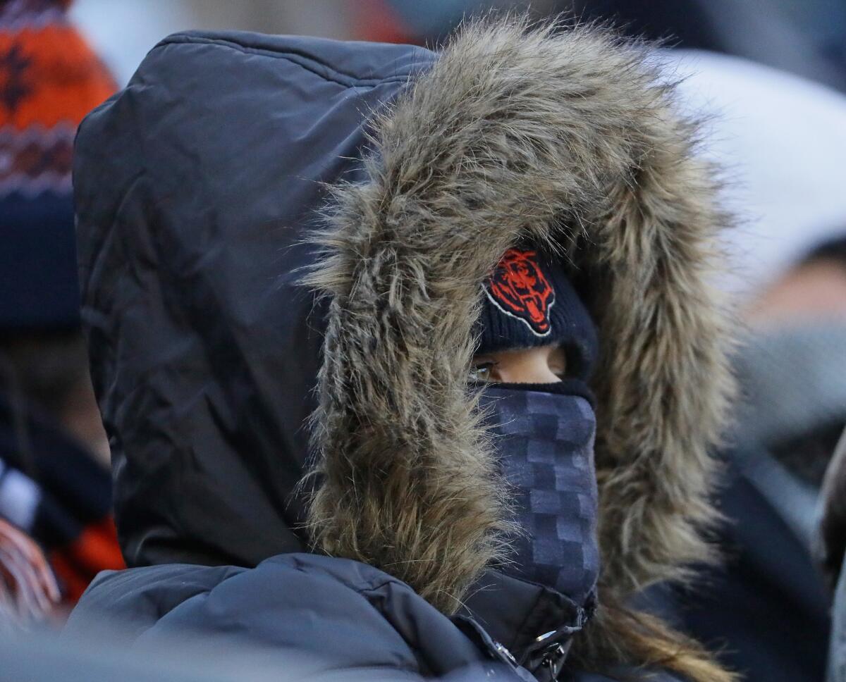 An NFL fan is bundled up during a game between the Chicago Bears and the Green Bay Packers at Soldier Field in Chicago on Sunday.