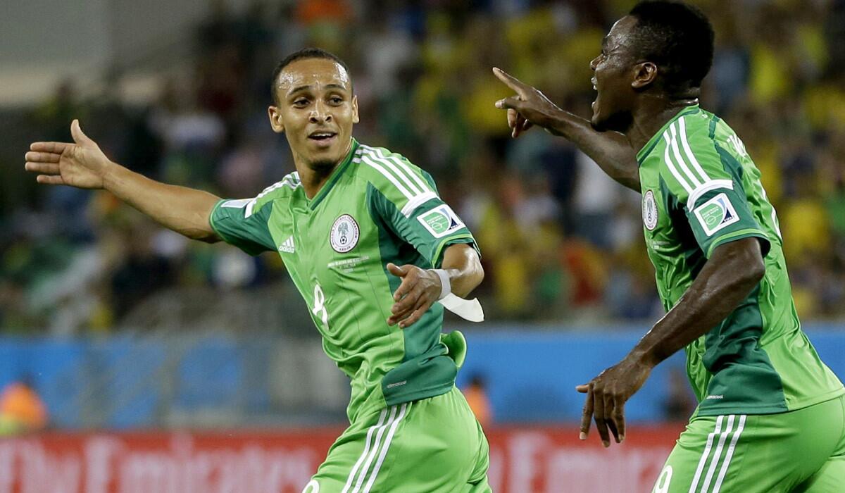 Nigeria forward Peter Odemwingie, left, celebrates with teammate Emmanuel Emenike after scoring against Bosnia-Herzegovina in a World Cup Group F game on Saturday at Arena Pantanal in Cuiaba, Brazil.