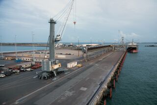 A crane hangs over Darwin Port in Darwin, Australia. The port has been leased to a Chinese company.