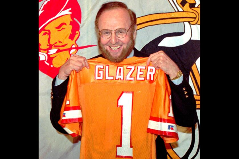 Malcolm Glazer with a replica jersey after agreeing to buy the Tampa Bay Buccaneers, which at the time had the worst record in NFL history.