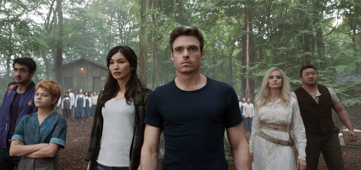 This image released by Marvel Studios shows,, from left, Kumail Nanjiani, Lia McHugh, Gemma Chan, Richard Madden, Angelina Jolie and Don Lee in a scene from "Eternals." (Marvel Studios-Disney via AP)