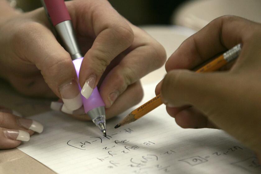 Students work on math problems at Martin Luther King High School in Riverside.