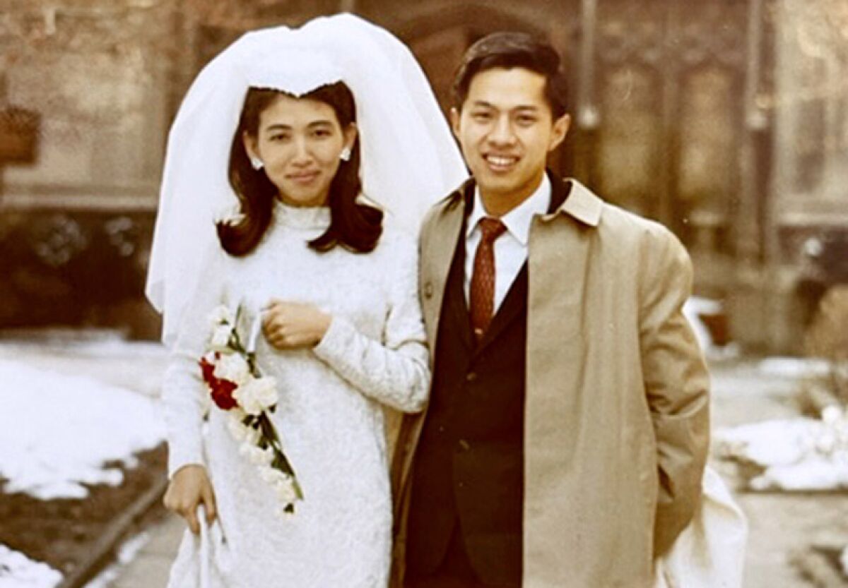 A bride, left, and groom, right, in a wedding photo.
