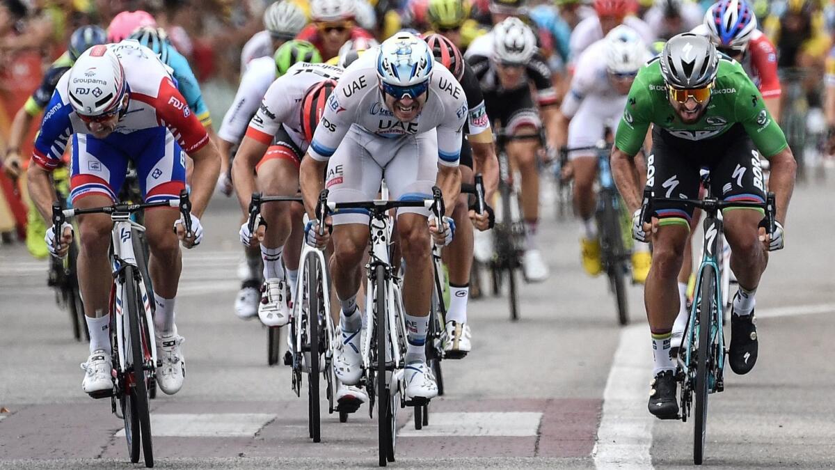 Peter Sagan, wearing the best sprinter's green jersey, passes Alexander Kristoff, center, and Arnaud Demare to win Stage 13 of the Tour de France.