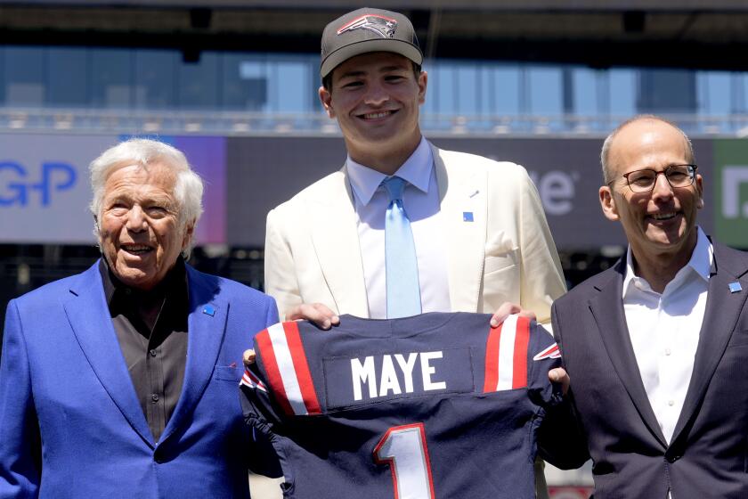 New England Patriots first round draft pick Drake Maye, former North Carolina quarterback, poses with team owner Robert Kraft, left, and team president Jonathan Kraft, right, during an NFL football news conference, Friday, April 26, 2024, in Foxborough, Mass. (AP Photo/Charles Krupa)