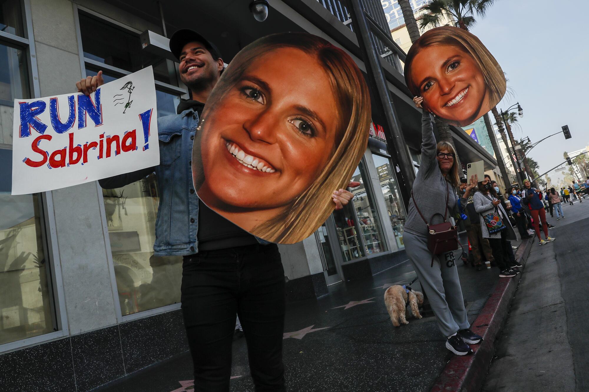 Jeff Crochet and Maria Belle cheer on Sabrina Belle as she runs along Hollywood Boulevard.
