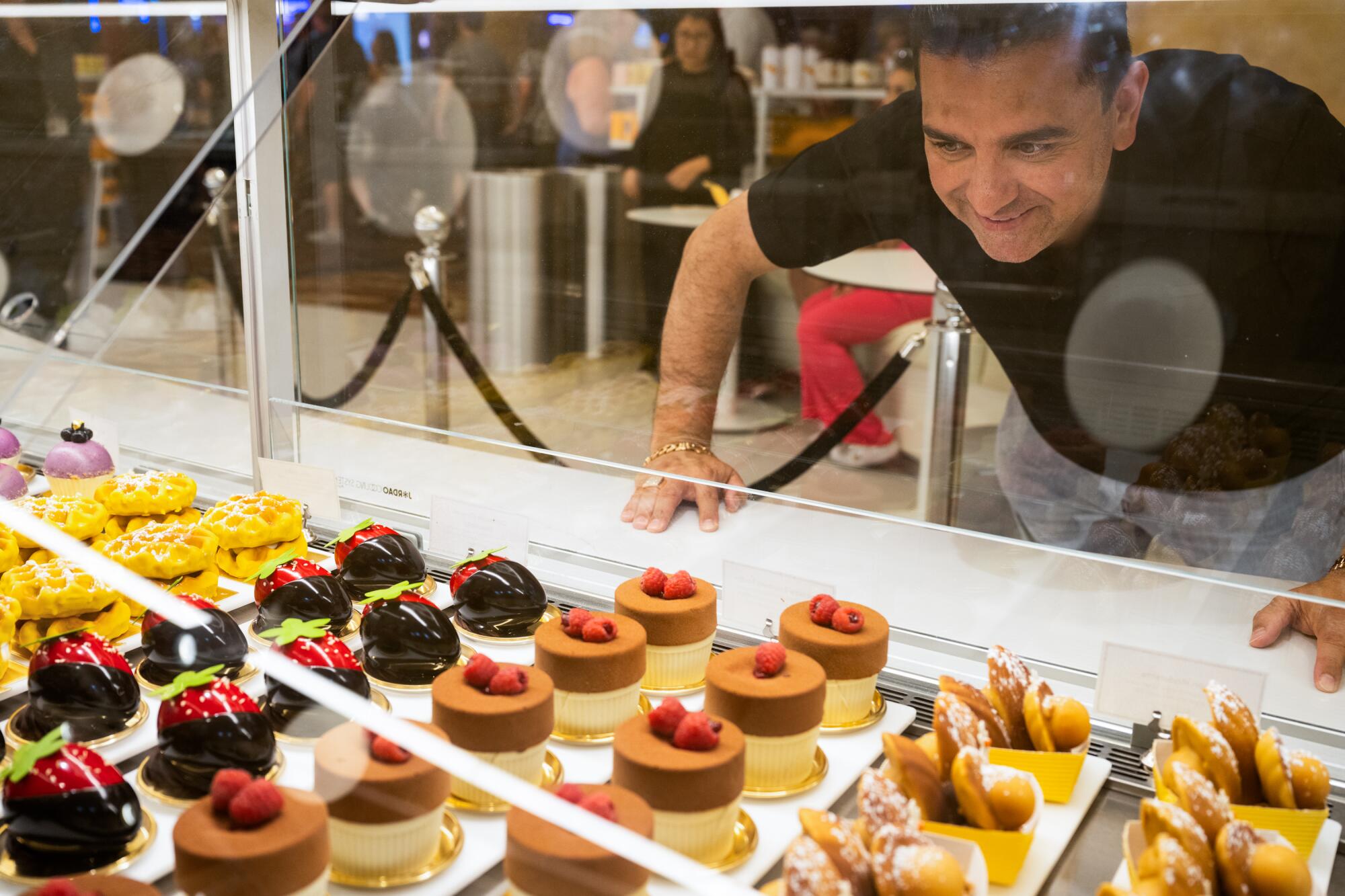 Buddy Valastro gazes at the pastries in the case at Dominique Ansel in Caesars Palace.