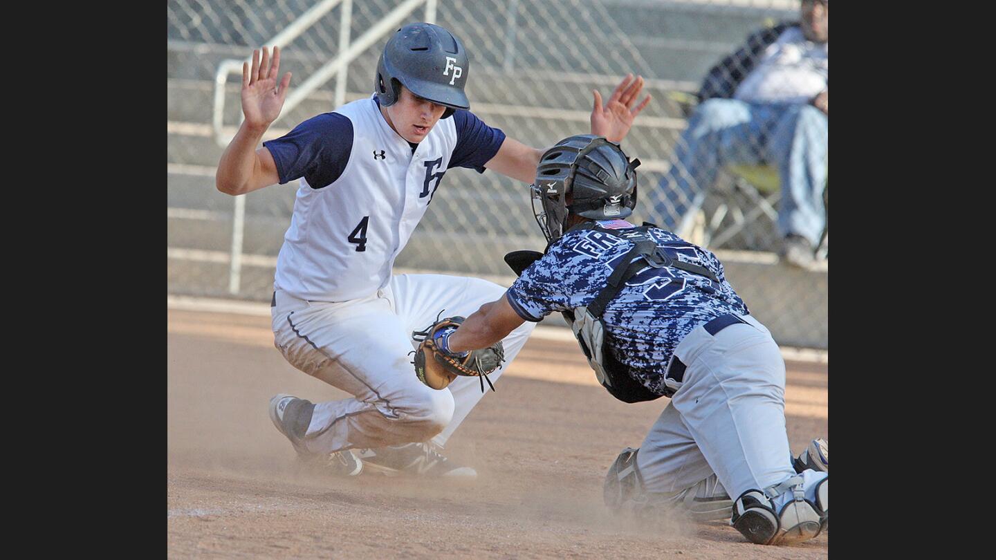 Flintridge Prep's Brian Pipes slides safely home and avoided the tag by the Arroyo Grande catcher in a CIF Division IV wildcard playoff baseball game at the Glendale Sports Complex on Wednesday, May 17, 2017.