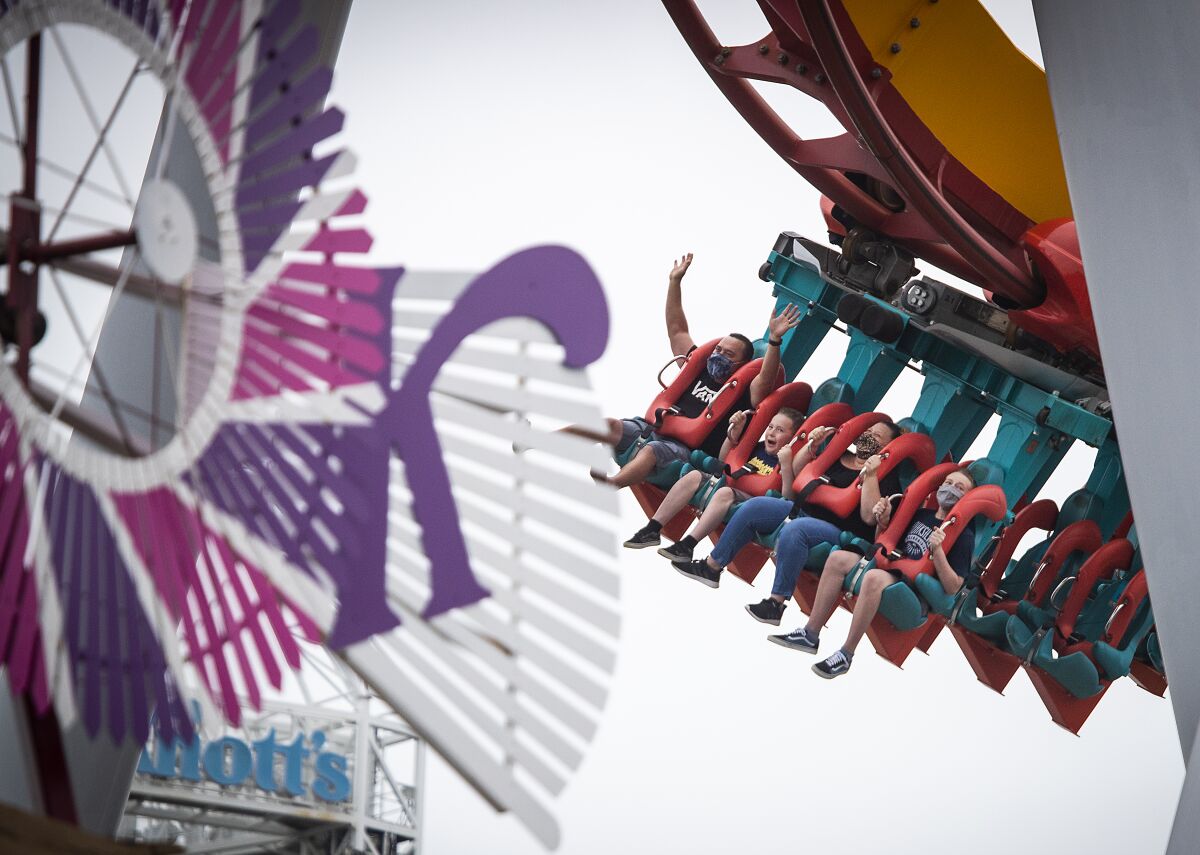Parkgoers ride the HangTime roller coaster at Knott’s Berry Farm in May 2021.