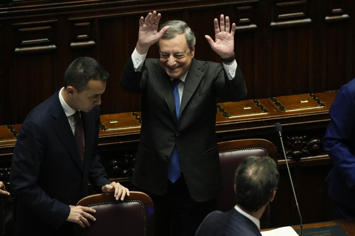 Italian Premier Mario Draghi waves to lawmakers at the end of his address at the Parliament in Rome, Thursday, July 21, 2022. Premier Mario Draghi's national unity government headed for collapse Thursday after key coalition allies boycotted a confidence vote, signaling the likelihood of early elections and a renewed period of uncertainty for Italy and Europe at a critical time. (AP Photo/Andrew Medichini)