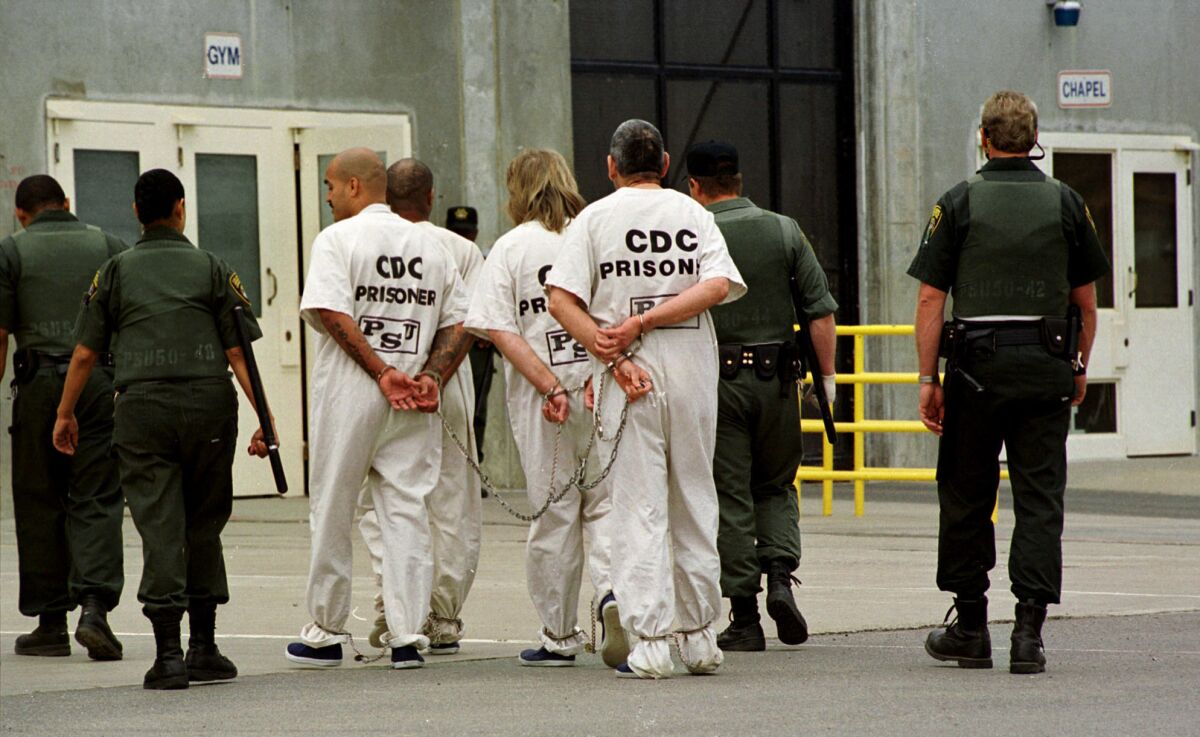 FILE — In this Oct. 28, 1999, file photo a group of inmates is moved from one cell unit to another at California State Prison Sacramento, in Folsom, Calif. California prison guard Sgt. Kevin Steele, 56, killed himself after reporting corruption and harassment at the prison to authorities and cooperating with attorneys suing the state according to the Sacramento Bee, Wednesday, Oct. 6, 2021. (AP Photo/Rich Pedroncelli, File)