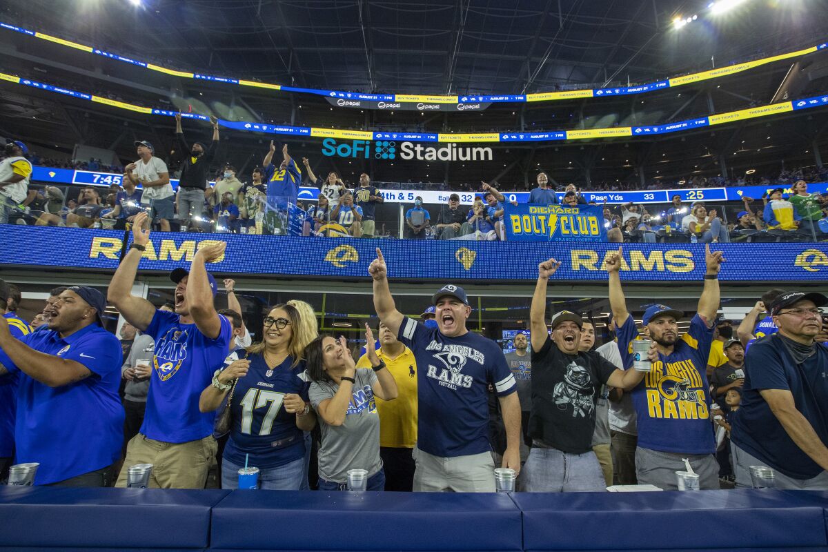 Fans cheer in the stands during the Chargers-Rams preseason game Saturday at SoFi Stadium.