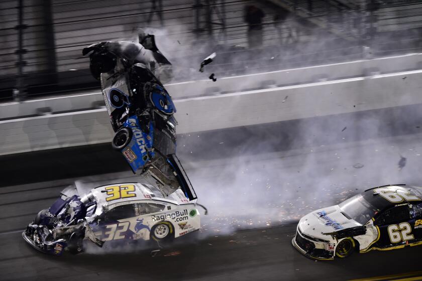 DAYTONA BEACH, FLORIDA - FEBRUARY 17: Denny Hamlin, driver of the #11 FedEx Express Toyota, wins over Ryan Blaney, driver of the #12 Menards/Peak Ford, as Ryan Newman, driver of the #6 Koch Industries Ford, crashes and flips behind them during the NASCAR Cup Series 62nd Annual Daytona 500 at Daytona International Speedway on February 17, 2020 in Daytona Beach, Florida. (Photo by Jared C. Tilton/Getty Images)