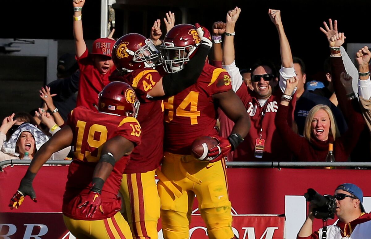 USC defensive end Rasheem Green (94) is congratulated by teammates after scoring a touchdown on a fumble return in the second half.