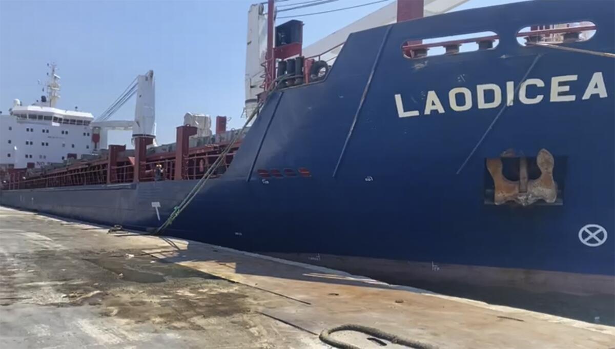This frame grab from a video provided on Friday, July 29, 2022, shows A Syrian cargo ship Laodicea docked at a seaport, in Tripoli, north Lebanon. Lebanon appeared Friday to reject claims by the Ukrainian Embassy in Beirut that a Syrian ship docked in a Lebanese port is carrying Ukrainian grain stolen by Russia, following an inspection by Lebanese customs officials. (AP Photo)