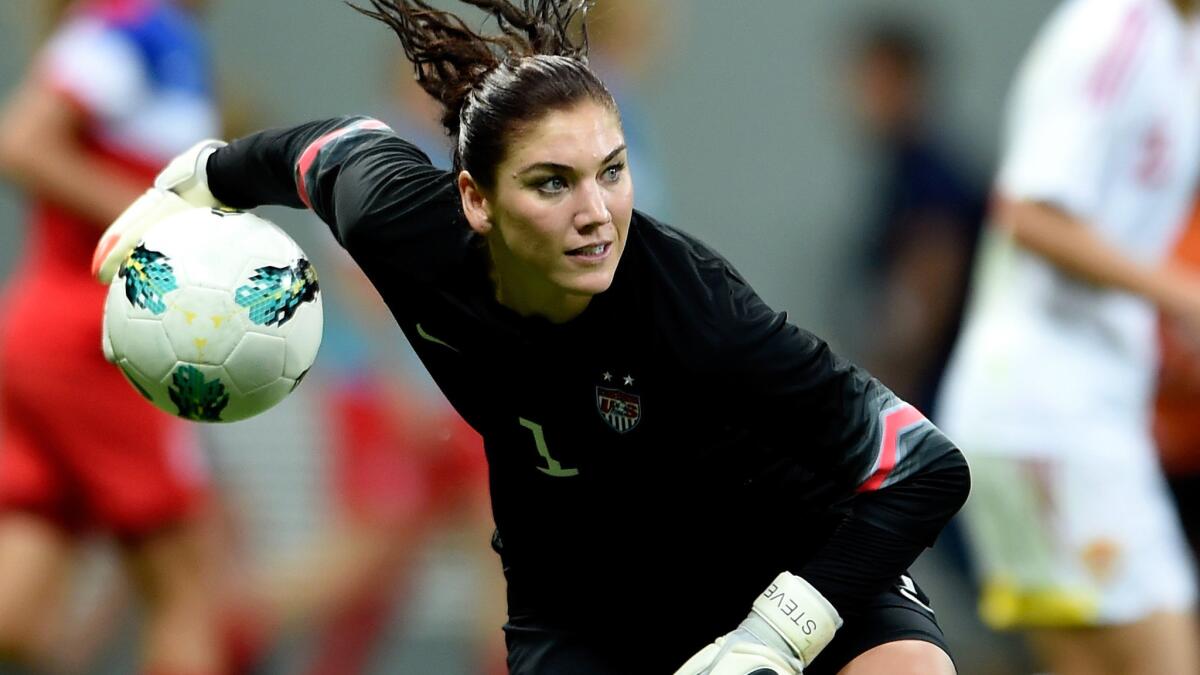 U.S. goalkeeper Hope Solo passes the ball during a match against China at the International Women's Football Tournament in Brasilia, Brazil, on Dec. 10.