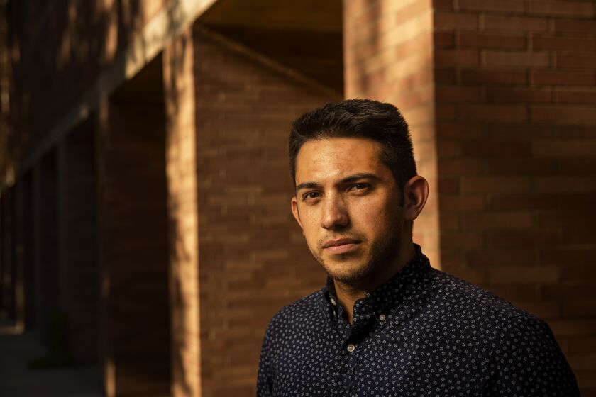 LOS ANGELES, CA-AUGUST 30, 2019: Adrian Rios, 26, a 2nd year law student at UCLA, is photographed outside the School of Law on August 30, 2019. Rios plans to practice corporate law and help his family ot and because of the anti-latino sentiment that has spread across the country, he wants to make sure he incorporates pro-bono work to help underprivileged Latinos. (Mel Melcon/Los Angeles Times)