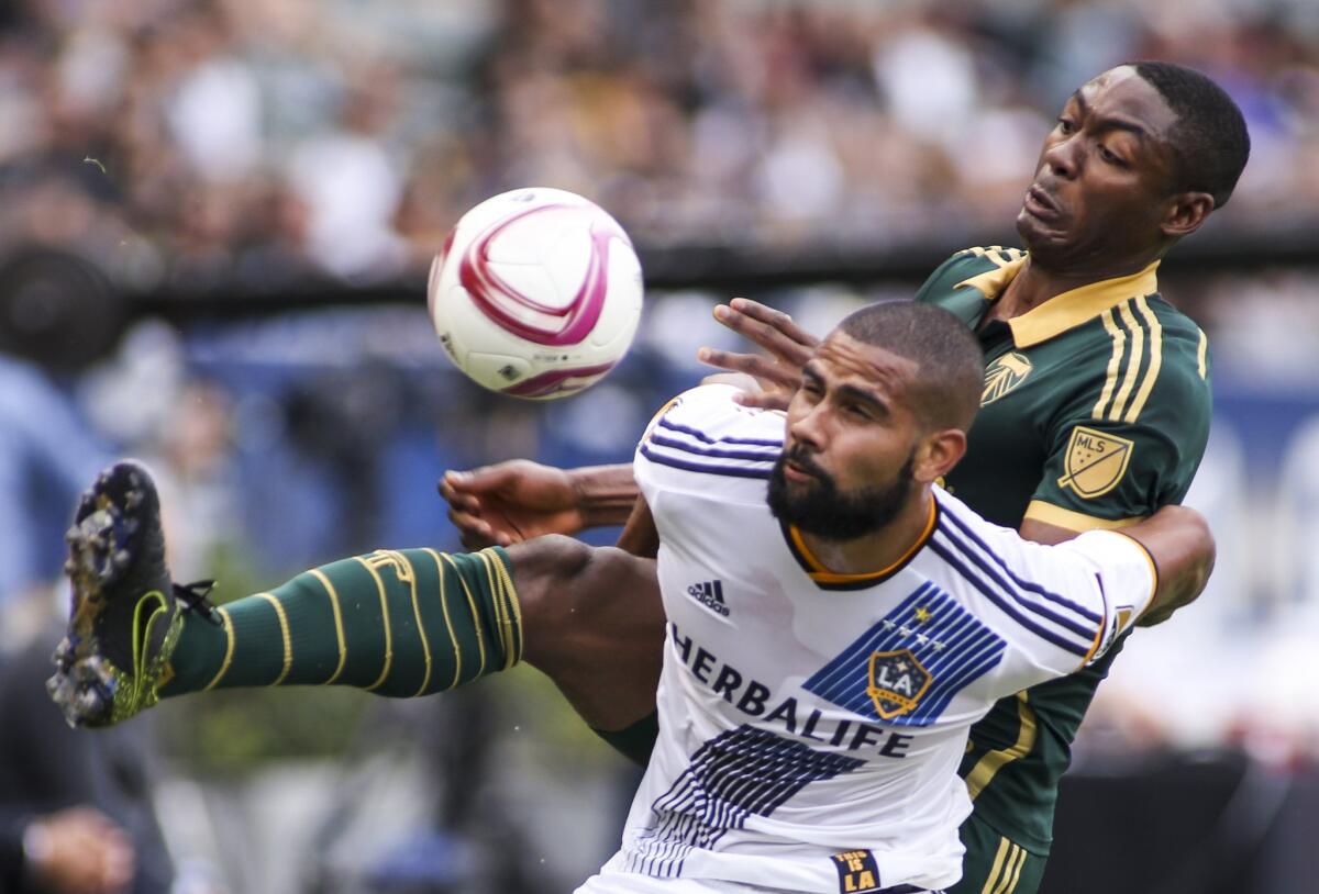 Galaxy defender Leonardo and Portland Timbers forward Fanendo Adi (9) in action during an MLS match on Oct. 18.