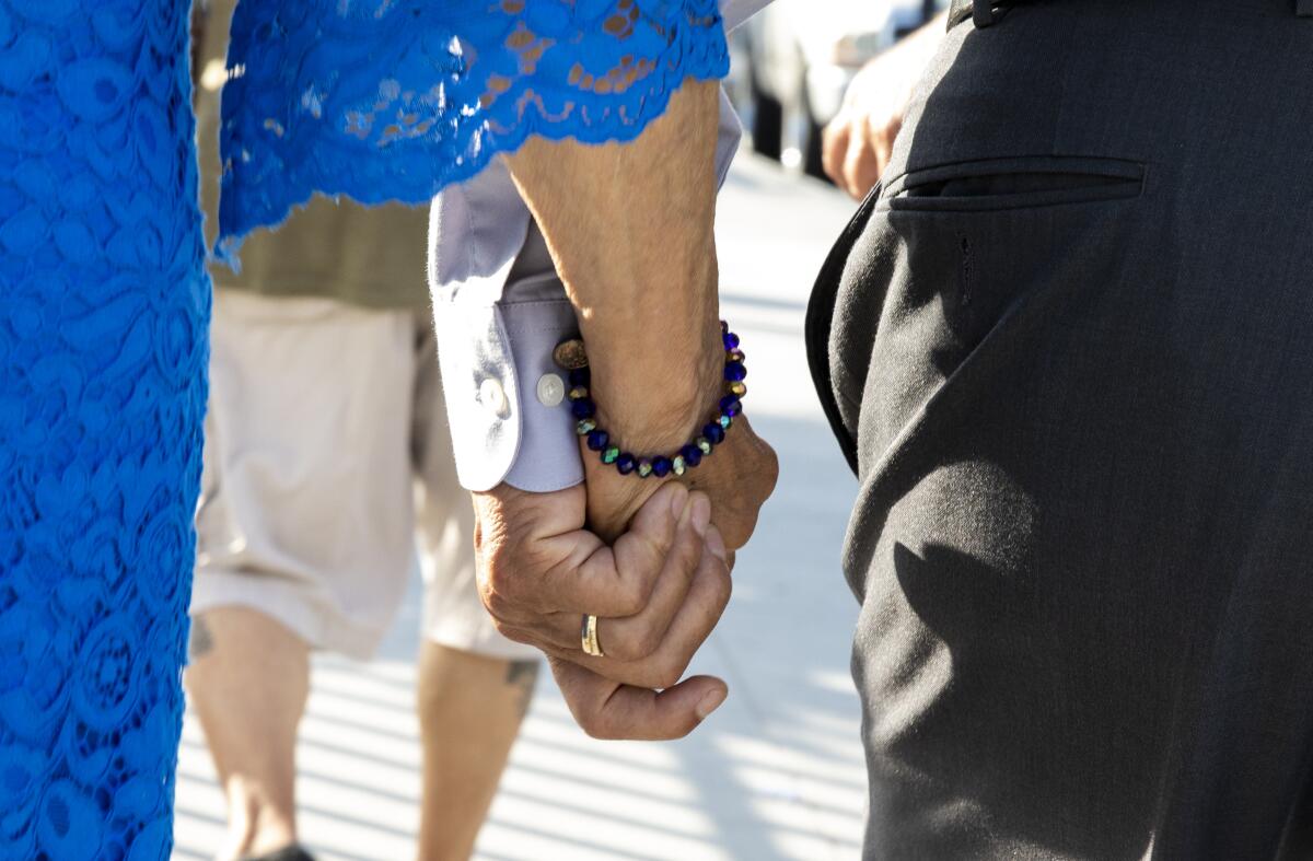 Agustin Abarca holds hands with his wife, Rosalba