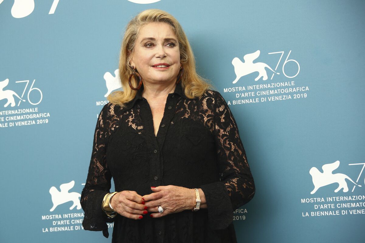 FILE - Actor Catherine Deneuve appears at the photo call for the film "The Truth" at the 76th edition of the Venice Film Festival in Venice, Italy, on Aug. 28, 2019. Deneuve will receive the Golden Lion for lifetime achievement award at the 79th Venice International Film Festival in September, organizers said Wednesday. Deneuve, now 78, was a key figure in the French New Wave thanks to collaborations with directors like Jacques Demy, Luis Buñuel and François Truffaut. She won the festival’s Golden Lion in 1967. (Photo by Joel C Ryan/Invision/AP, File)