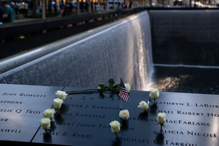  White flowers are placed at the names of people who died in the 9/11 attacks at the memorial in New York on Sept. 3, 2021.