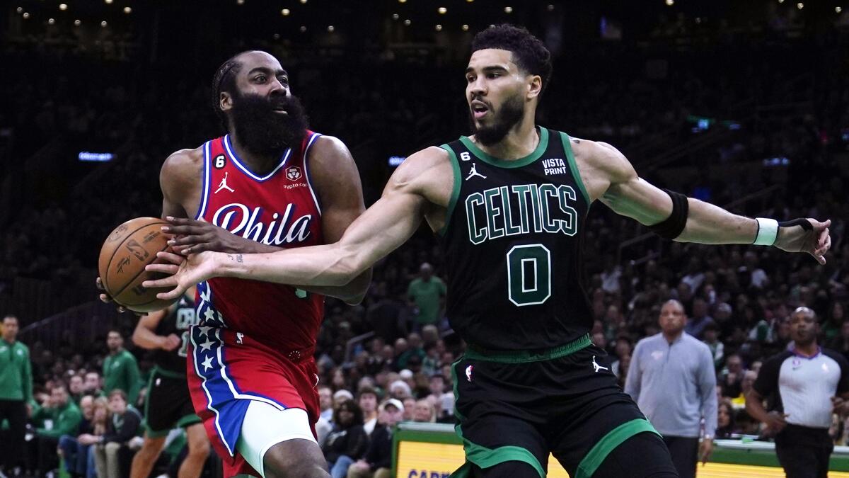 Boston's Jayson Tatum, right, tries to steal the ball from a driving James Harden.