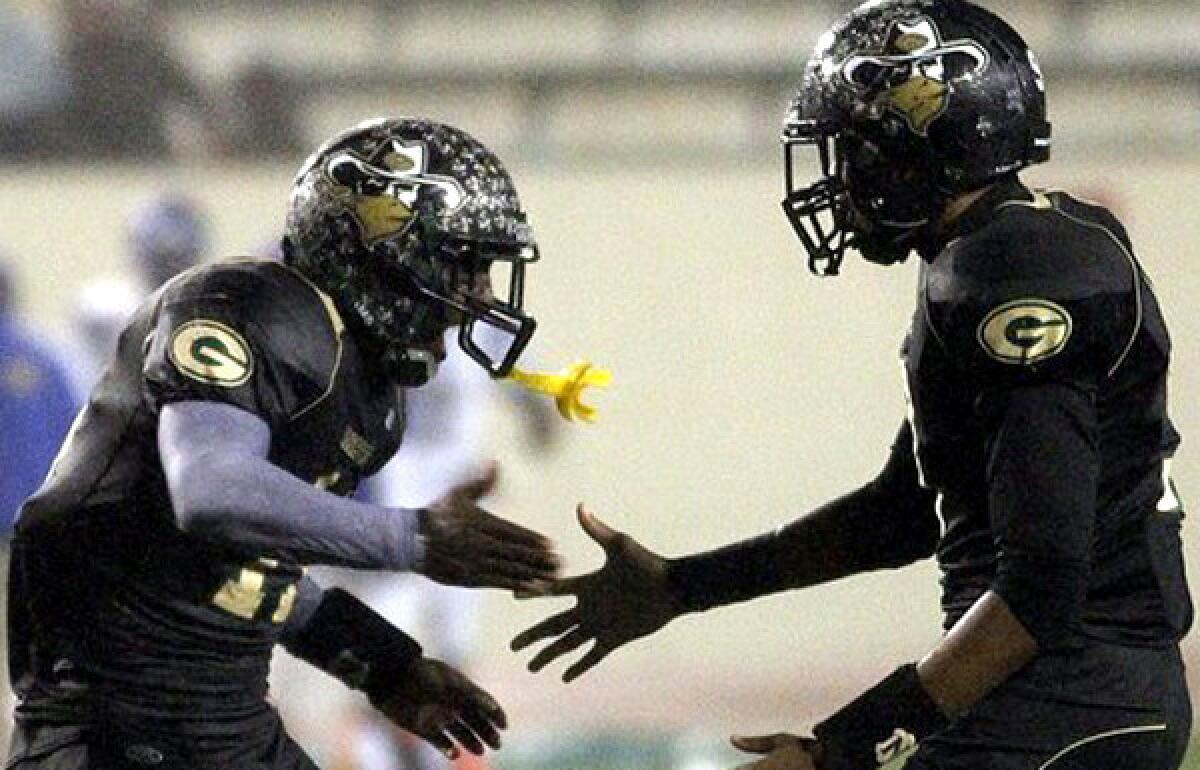 Narbonne wide receiver A.J. Richardson is congratulated by teammate Josh Collins after making a touchdown catch against Crenshaw in the fourth quarter of the City Section Division I championship game Saturday at East Los Angeles College.