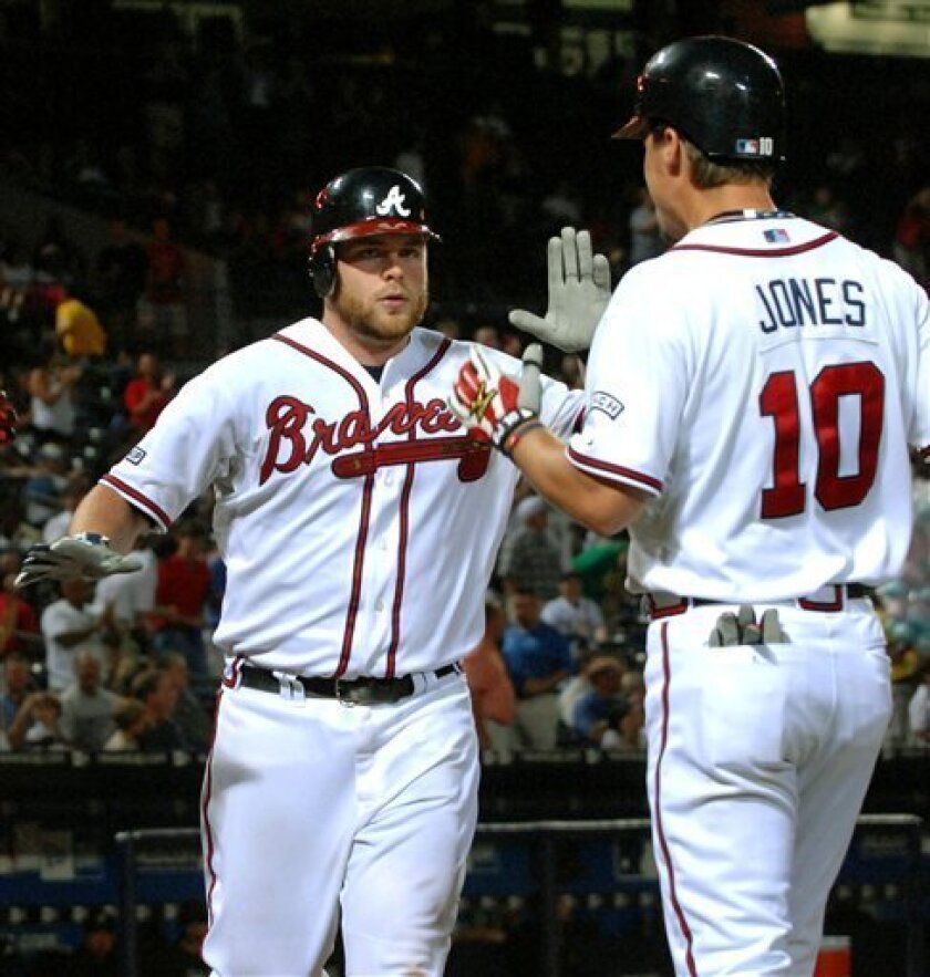 Atlanta Braves' Brian McCann, left, celebrates with teammate Chipper Jones (10) while scoring against the Florida Marlins on a three-run home run during the fifth inning of a Major League baseball game, Thursday, Aug. 28, 2008, at Turner Field in Atlanta. (AP Photo/Gregory Smith)