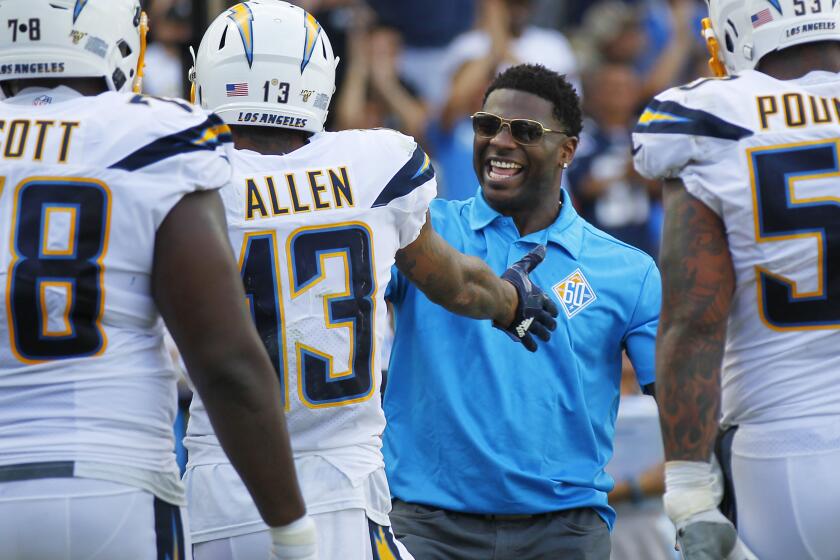 Los Angeles Chargers Keenan Allen celebrates with LaDainian Tomlinson after scoring a touchdown against the Houston Texans in the 2nd quarter in Carson on Sept. 22, 2019.