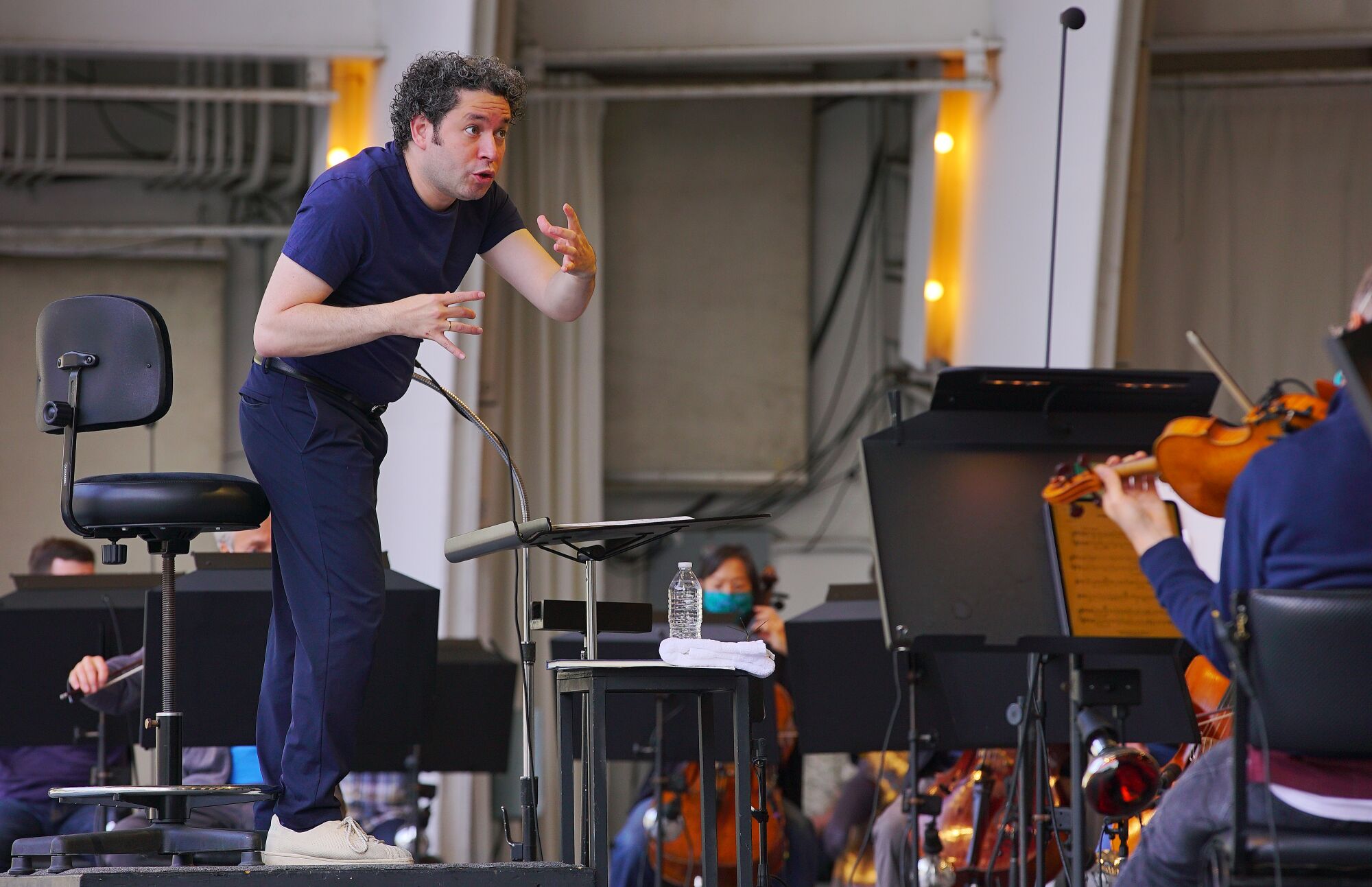 Dudamel gestures as he conducts rehearsal