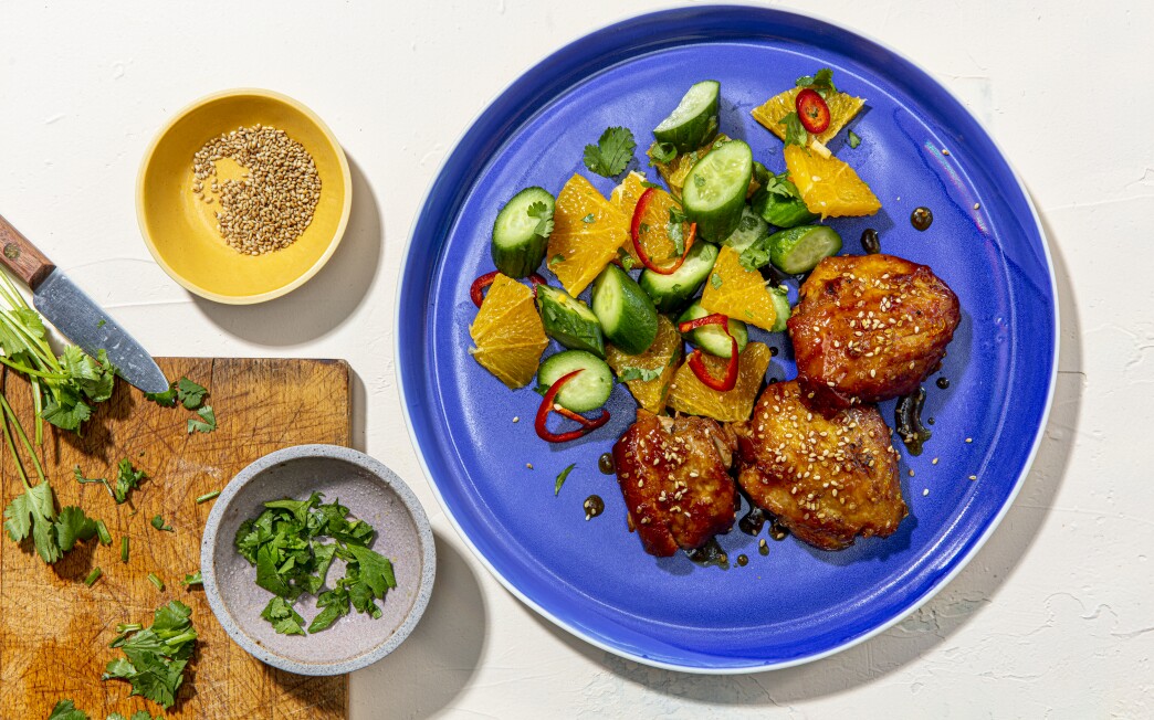 Orange zest, honey and soy sauce reduce to a sticky sauce for chicken thighs served with a bright orange and cucumber salad.