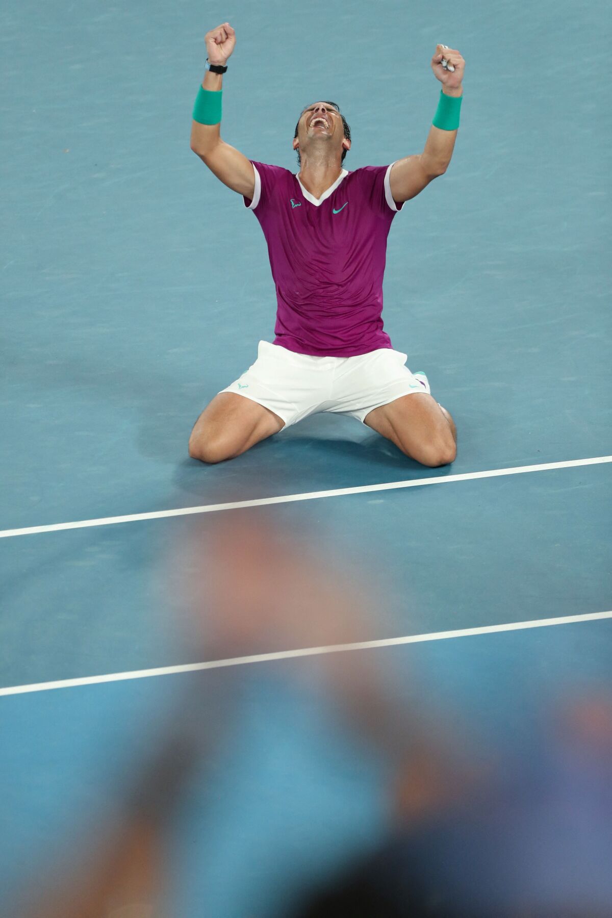 Rafael Nadal kneels on the tennis court after his win