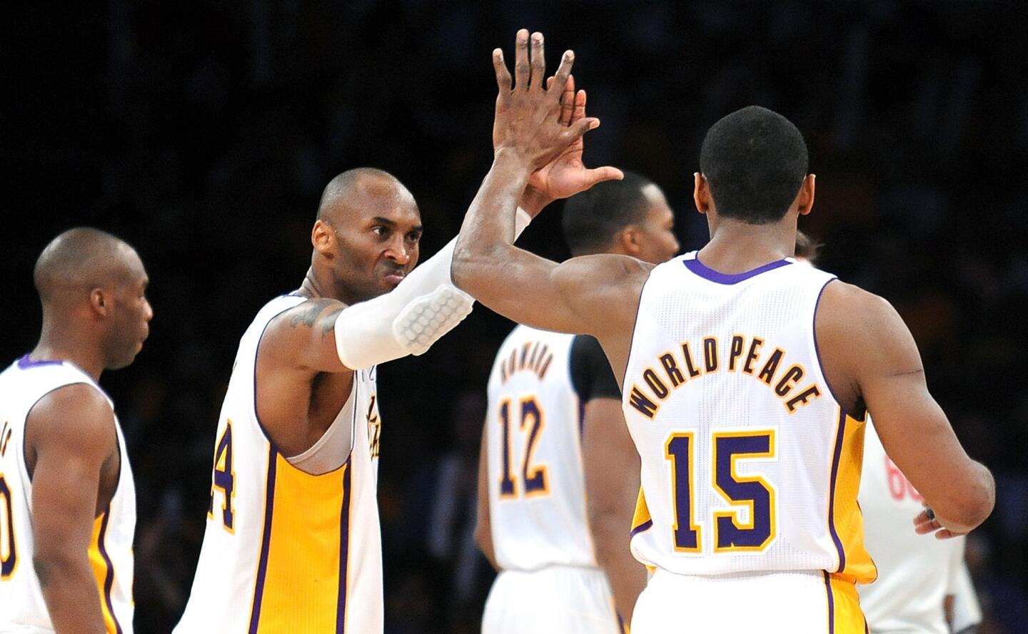 Lakers guard Kobe Bryant and forward Metta World Peace celebrate as they approach a victory over the Bulls on Sunday afternoon at Staples Center.