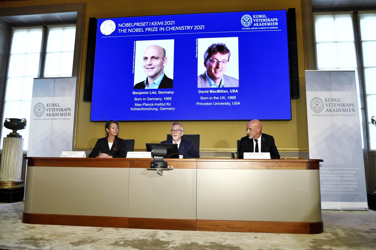 Goran Hansson of the Royal Swedish Academy of Sciences (center) announces the winners of the 2021 Nobel Prize in chemistry.