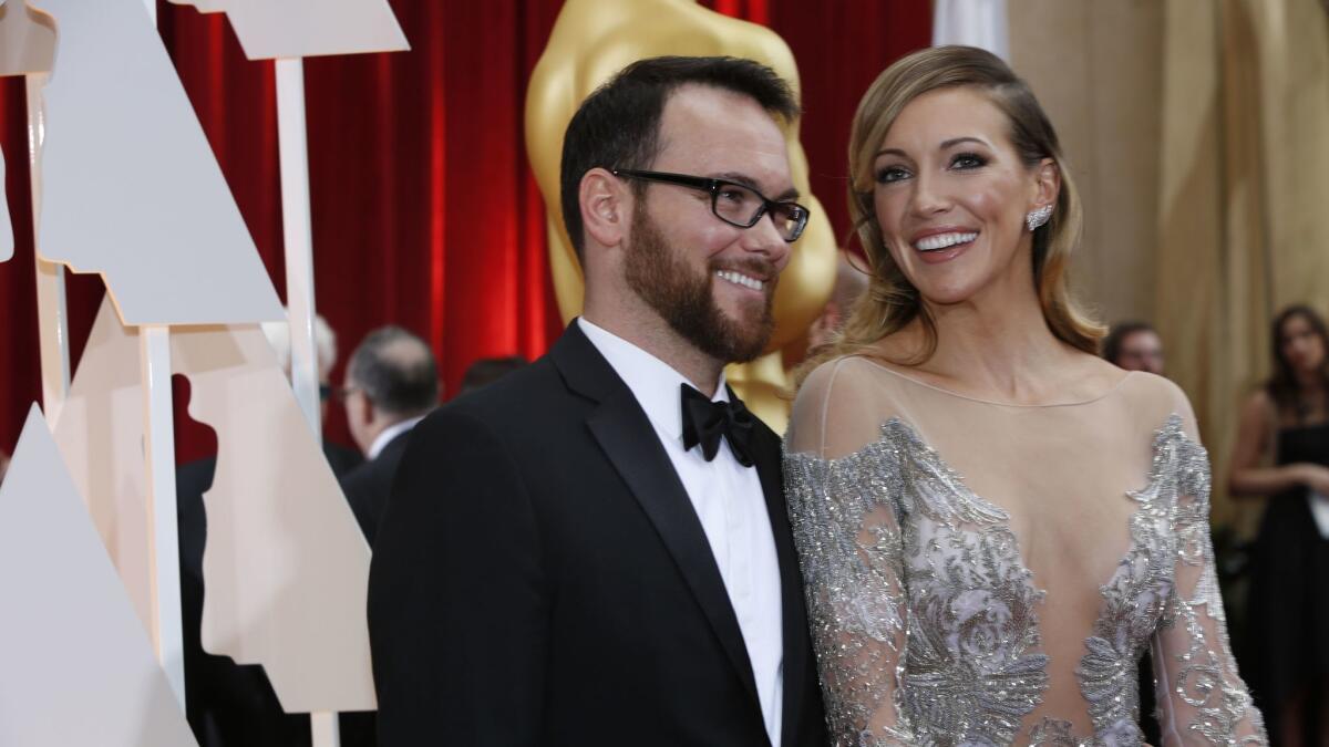 Producer Dana Brunetti and actress Katie Cassidy arrive at the 87th Annual Academy Awards on Feb. 22, 2015, at the Dolby Theatre.