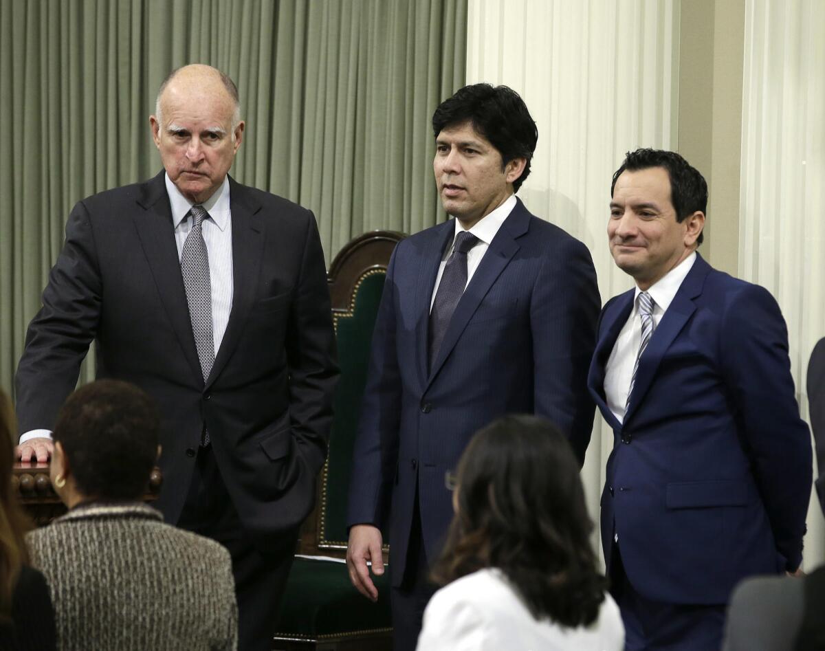 Gov. Jerry Brown, left, with Senate President Pro Tem Kevin de León (D-Los Angeles), center, and Assembly Speaker Anthony Rendon (D-Paramount).
